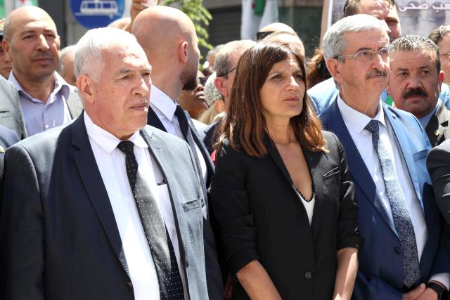 France's junior Minister for Veterans affairs Alice Rufo (C) stands next to Algerian Minister of the Mujahideen and Beneficiaries Abdelmalek Tacherift (L), during a commemoration ceremony marking the anniversary of the "1945 Setif massacres" in the eastern city of Setif on May 8, 2026. France announced on May 8,  the return of its ambassador to Algeria, coinciding with a ministerial visit aimed at “building trusting relations” and “restoring effective dialogue” with Algiers, following nearly two years of diplomatic crisis between the two countries. (Photo by AFP)