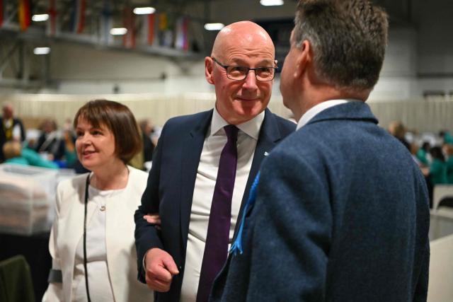 Scotland's First Minister and Scottish National Party (SNP) leader John Swinney and his wife Elizabeth attend a vote-counting centre the day after parliamentary elections at the Dewars Centre in Perth, Perthshire, Scotland on May 8, 2026. (Photo by ANDY BUCHANAN / AFP)