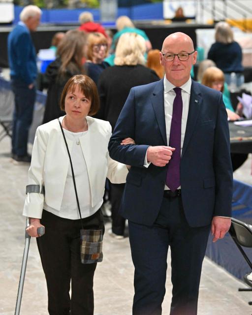 Scotland's First Minister and Scottish National Party (SNP) leader John Swinney and his wife Elizabeth  attend a vote-counting centre the day after parliamentary elections at the Dewars Centre in Perth, Perthshire, Scotland on May 8, 2026. (Photo by ANDY BUCHANAN / AFP)