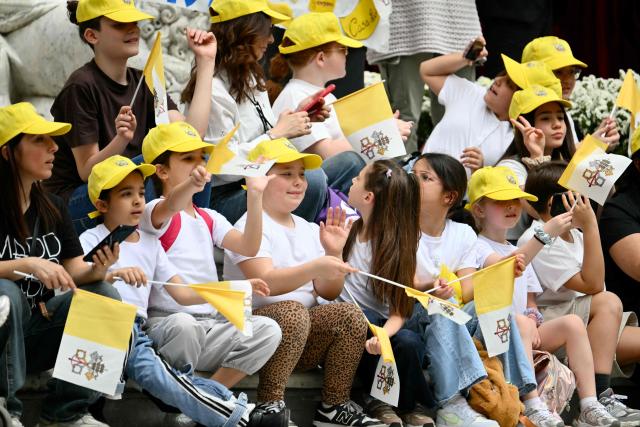 School children wait for the arrival of Pope Leo XIV outside Naples Cathedral during a pastoral visit in Naples on May 8, 2026. (Photo by Alberto PIZZOLI / AFP)