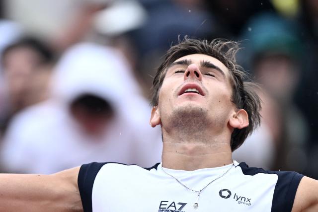Italy's Matteo Arnaldi celebrates after winning against Australia's Alex de Minaur during their men's singles match of the WTA Rome Open tennis tournament at the Foro Italico in Rome on May 8, 2026. (Photo by Tiziana FABI / AFP)