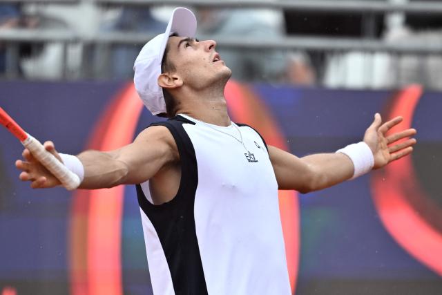 Italy's Matteo Arnaldi celebrates after winning against Australia's Alex de Minaur during their men's singles match of the WTA Rome Open tennis tournament at the Foro Italico in Rome on May 8, 2026. (Photo by Tiziana FABI / AFP)
