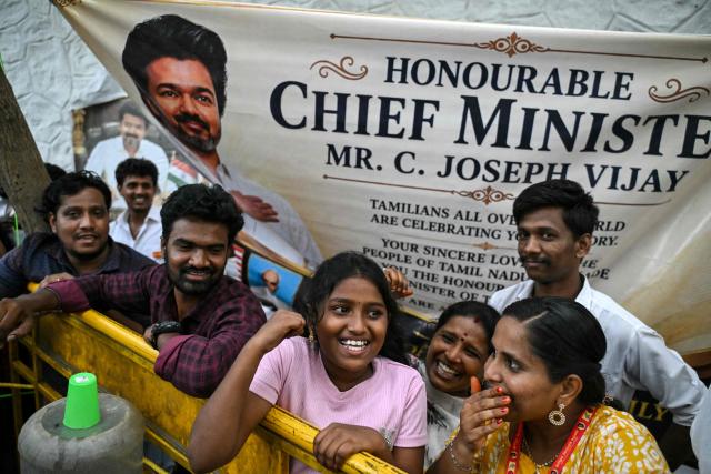Supporters and members of India’s actor C. Joseph Vijay's Tamilaga Vettri Kazhagam (TVK) party celebrate after TVK gains support from other political parties to form the government in the Tamil Nadu state, at their party headquarters in Chennai on May 8, 2026. Local media reported on May 8 that the former film star had secured the support of two communist parties and the opposition Congress party to cross the majority mark. Popularly known as Vijay, the 51-year-old is now almost sure to lead the state. (Photo by R. Satish BABU / AFP)