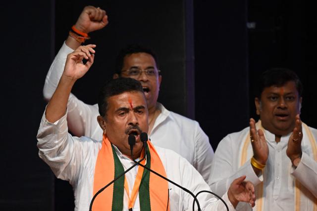 Bharatiya Janata Party (BJP) leader and newly selected Chief Minister of West Bengal Suvendu Adhikari (L) gestures during a party meeting in Kolkata on May 8, 2026. Indian Prime Minister Narendra Modi's party named a chief minister of West Bengal state on May 8, cementing its thumping win in key elections in the bastion long held by its adversary. (Photo by Dibyangshu SARKAR / AFP)