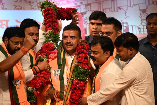 Bharatiya Janata Party (BJP) leader and newly selected Chief Minister of West Bengal Suvendu Adhikari (3L) gestures during a party meeting in Kolkata on May 8, 2026. Indian Prime Minister Narendra Modi's party named a chief minister of West Bengal state on May 8, cementing its thumping win in key elections in the bastion long held by its adversary. (Photo by Dibyangshu SARKAR / AFP)