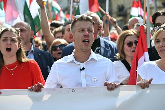 (FILES) Peter Magyar (C), Hungarian lawyer, former government insider and ex-husband of former Justice Minister Varga, together with political opposition activists and supporters takes part in a march and demonstration in downtown Budapest on April 6, 2024, to denounce the Hungarian government and corruption. Pro-European conservative Peter Magyar will be officially sworn in as Prime Minister by the Hungarian parliament on May 9, 2026, just under a month after his landslide victory in the parliamentary elections against nationalist Viktor Orban. (Photo by Attila KISBENEDEK / AFP)
