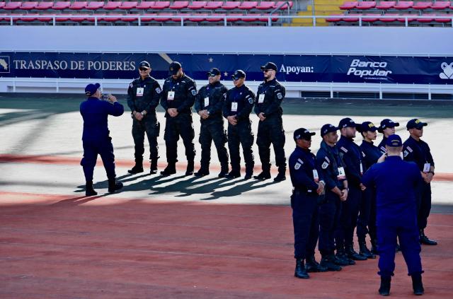 Police officers pose for a picture ahead of the inauguration ceremony of Costa Rica's president-elect Laura Fernandez, in San Jose, on May 8, 2026. (Photo by EZEQUIEL BECERRA / AFP)
