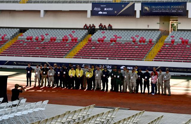 Police officers and firefighters pose for a picture ahead of the inauguration ceremony of Costa Rica's president-elect Laura Fernandez, at the National Stadium in San Jose, on May 8, 2026. (Photo by EZEQUIEL BECERRA / AFP)