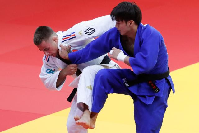 France's Enzo Jean (white) and Taiwan's Yang Yung-wei compete in the men's under 60 kg bronze medal bout at the Astana Grand Slam judo tournament in Astana on May 8, 2026. (Photo by STANISLAV FILIPPOV / AFP)