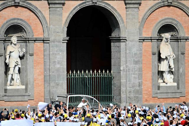 Pope Leo XIV waves to the crowd as he arrives at the Piazza del Plebiscito for a holy mass as part of a pastoral visit in Naples on May 8, 2026. (Photo by Alberto PIZZOLI / AFP)