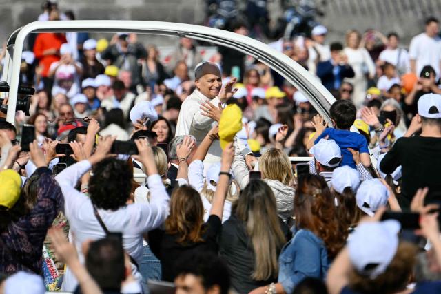 Pope Leo XIV waves to the crowd as he arrives at the Piazza del Plebiscito for a holy mass as part of a pastoral visit in Naples on May 8, 2026. (Photo by Alberto PIZZOLI / AFP)