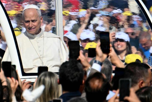 Pope Leo XIV waves to the crowd as he arrives at the Piazza del Plebiscito for a holy mass as part of a pastoral visit in Naples on May 8, 2026. (Photo by Alberto PIZZOLI / AFP)