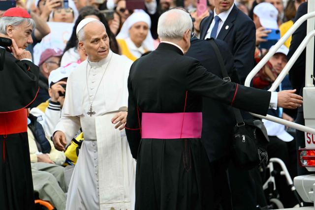 Pope Leo XIV arrives with Italian cardinal Domenico Battaglia at Piazza del Plebiscito before a holy mass as part of a pastoral visit in Naples on May 8, 2026. (Photo by Alberto PIZZOLI / AFP)