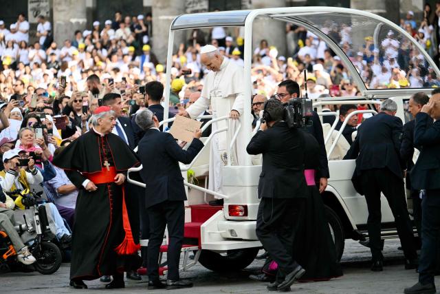 Pope Leo XIV arrives with Italian cardinal Domenico Battaglia at Piazza del Plebiscito before a holy mass as part of a pastoral visit in Naples on May 8, 2026. (Photo by Alberto PIZZOLI / AFP)