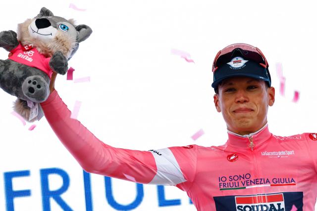 Soudal Quick-Step French rider Paul Magnier wearing the overall leader's pink jersey (Maglia Rosa) poses on the podium after winning the 1st stage of the Giro d'Italia 2026 - Tour of Italy cycling race between Nessebar and Burgas, Bulgaria, on May 8, 2026. (Photo by Luca Bettini / AFP)