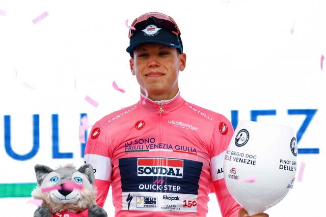 Soudal Quick-Step French rider Paul Magnier wearing the overall leader's pink jersey (Maglia Rosa) poses on the podium after winning the 1st stage of the Giro d'Italia 2026 - Tour of Italy cycling race between Nessebar and Burgas, Bulgaria, on May 8, 2026. (Photo by Luca Bettini / AFP)