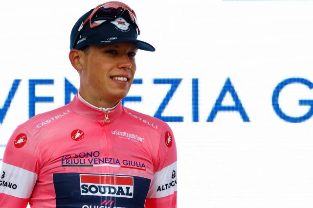 Soudal Quick-Step French rider Paul Magnier wearing the overall leader's pink jersey (Maglia Rosa) looks on on the podium after winning the 1st stage of the Giro d'Italia 2026 - Tour of Italy cycling race between Nessebar and Burgas, Bulgaria, on May 8, 2026. (Photo by Luca Bettini / AFP)