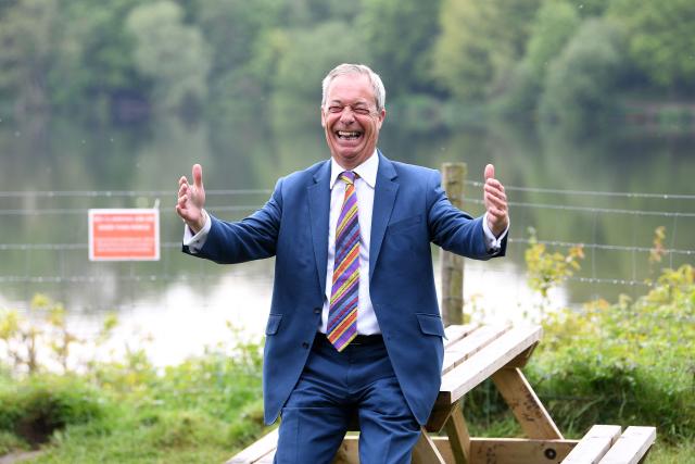 Reform UK leader Nigel Farage reacts during a visit to St Helens, north west England on May 8, 2026, as votes continue to be counted following local elections. Nigel Farage, leader of the Britain's hard-right nationalist Reform UK party, vowed Friday it was "here to stay" after winning hundreds of seats in local polls. (Photo by PETER POWELL / AFP)