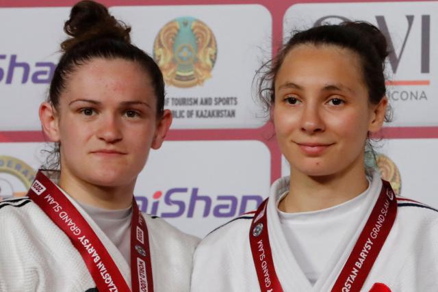 Silver medallist France's Chloe Devictor and gold medallist France's Faiza Mokdar celebrate during the podium ceremony for the women's under 57 kg event at the Astana Grand Slam judo tournament in Astana on May 8, 2026. (Photo by STANISLAV FILIPPOV / AFP)
