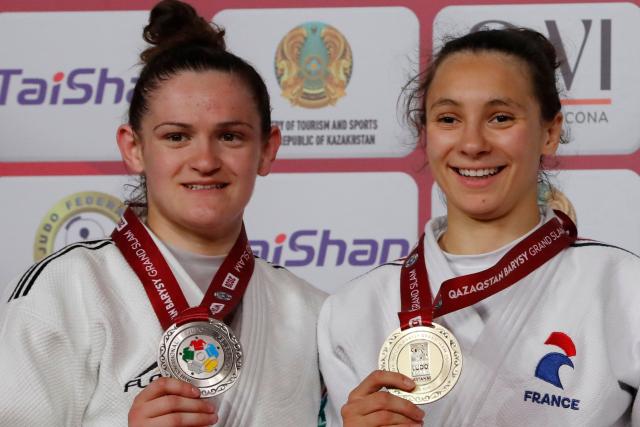 Silver medallist France's Chloe Devictor and gold medallist France's Faiza Mokdar celebrate during the podium ceremony for the women's under 57 kg event at the Astana Grand Slam judo tournament in Astana on May 8, 2026. (Photo by STANISLAV FILIPPOV / AFP)