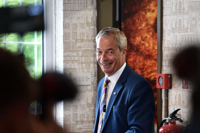 Reform UK leader Nigel Farage reacts during a visit to St Helens, north west England on May 8, 2026, as votes continue to be counted following local elections. Nigel Farage, leader of the Britain's hard-right nationalist Reform UK party, vowed Friday it was "here to stay" after winning hundreds of seats in local polls. (Photo by PETER POWELL / AFP)