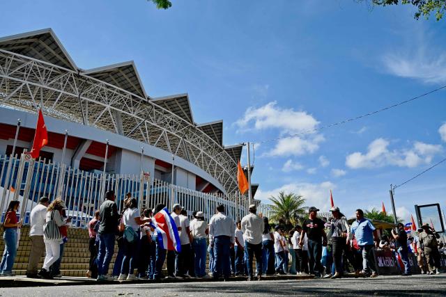 Attendees wait in line to enter for the inauguration ceremony of Costa Rica's President-elect Laura Fernandez, at the National Stadium in San Jose, on May 8, 2026. (Photo by EZEQUIEL BECERRA / AFP)