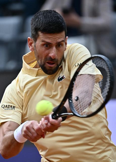 Serbia's Novak Djokovic plays a backhand return to Croatia's Dino Prizmic during their men's singles match of the WTA Rome Open tennis tournament at the Foro Italico in Rome on May 8, 2026. (Photo by Filippo MONTEFORTE / AFP)