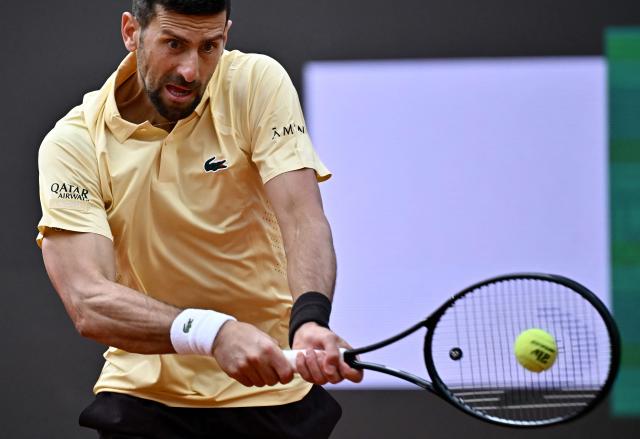 Serbia's Novak Djokovic plays a backhand return to Croatia's Dino Prizmic during their men's singles match of the WTA Rome Open tennis tournament at the Foro Italico in Rome on May 8, 2026. (Photo by Filippo MONTEFORTE / AFP)