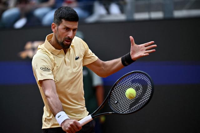 Serbia's Novak Djokovic plays a backhand return to Croatia's Dino Prizmic during their men's singles match of the WTA Rome Open tennis tournament at the Foro Italico in Rome on May 8, 2026. (Photo by Filippo MONTEFORTE / AFP)