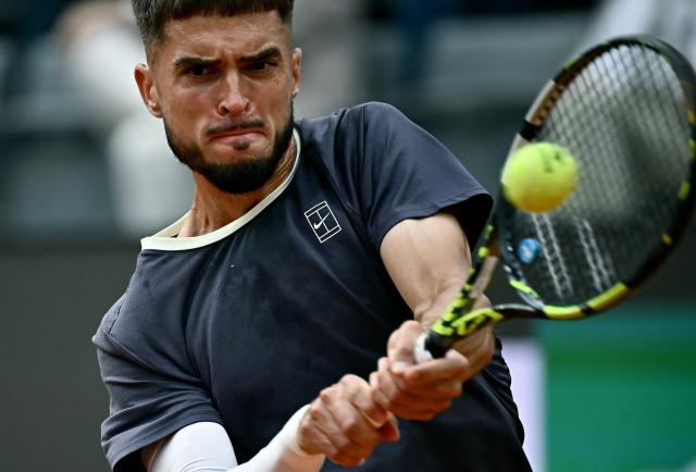 Croatia's Dino Prizmic plays a backhand return to Serbia's Novak Djokovic during their men's singles match of the WTA Rome Open tennis tournament at the Foro Italico in Rome on May 8, 2026. (Photo by Filippo MONTEFORTE / AFP)