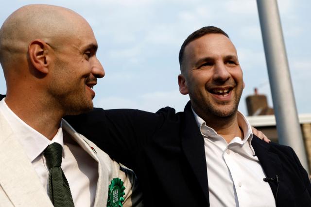 Green Party leader Zack Polanski (R) congratulates the party's newly elected Mayor of Lewisham, Liam Shrivastava, outside the count centre in Lewisham, south London on May 8, 2026. Nigel Farage's anti-immigrant Reform UK and the left-wing Greens, led by self-described eco-populist Zack Polanski, werw expected to benefit from widespread disillusionment. (Photo by Brook Mitchell / AFP)