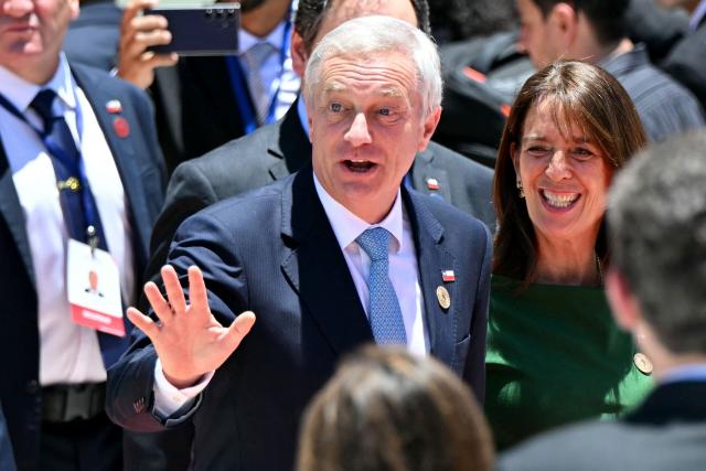 Chile's President Jose Antonio Kast (L) waves next to First Lady Maria Pia Adriasola (R) as they arrive for the inauguration ceremony of Costa Rica's president-elect Laura Fernandez at the National Stadium in San Jose on May 8, 2026. (Photo by MARTIN BERNETTI / AFP)