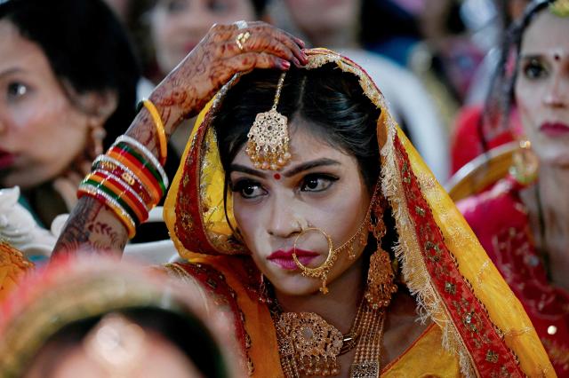 A Pakistani Hindu bride looks on during a mass marriage ceremony organised by the Cutchi Maheshwari Welfare Association in Karachi on May 8, 2026. (Photo by Rizwan TABASSUM / AFP)