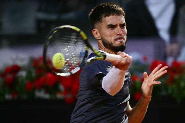 Croatia's Dino Prizmic plays a backhand return to Serbia's Novak Djokovic during their men's singles match of the WTA Rome Open tennis tournament at the Foro Italico in Rome on May 8, 2026. (Photo by Filippo MONTEFORTE / AFP)