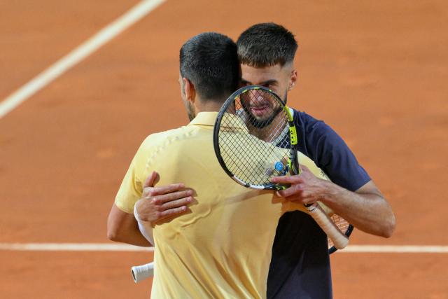 Croatia's Dino Prizmic (R) embraces Serbia's Novak Djokovic after winning their men's singles match of the WTA Rome Open tennis tournament at the Foro Italico in Rome on May 8, 2026. (Photo by Tiziana FABI / AFP)