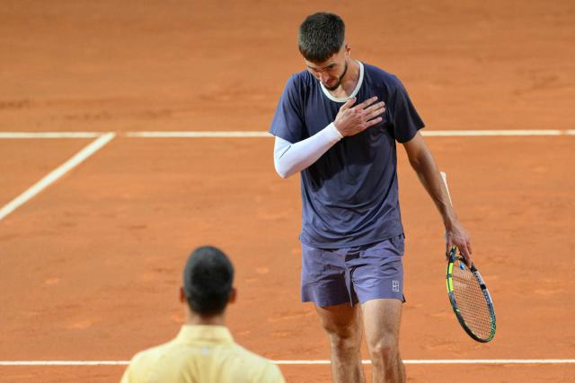 Croatia's Dino Prizmic (R) bows before Serbia's Novak Djokovic after winning their men's singles match of the WTA Rome Open tennis tournament at the Foro Italico in Rome on May 8, 2026. (Photo by Tiziana FABI / AFP)