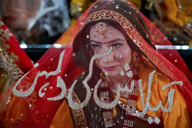 A Pakistani Hindu bride looks on during a mass marriage ceremony organised by the Cutchi Maheshwari Welfare Association in Karachi on May 8, 2026. (Photo by Rizwan TABASSUM / AFP)