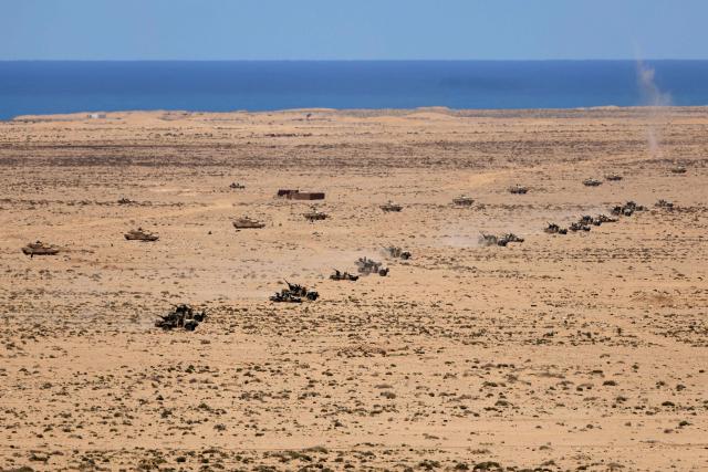 Military vehicles drive in formation during the "African Lion" joint military exercise between US and Moroccan forces in the Tan-Tan region in southwestern Morocco on May 8, 2026. (Photo by Abdel Majid BZIOUAT / AFP)