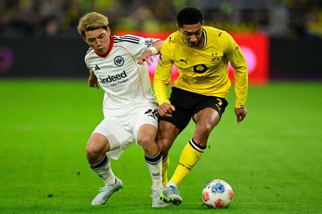 Frankfurt's Japanese forward #20 Ritsu Doan (L) and Dortmund's English midfielder #07 Jobe Bellingham vie for the ball during the German first division Bundesliga football match between BVB Borussia Dortmund and Eintracht Frankfurt in Dortmund, western Germany on May 8, 2026. (Photo by INA FASSBENDER / AFP) / DFL REGULATIONS PROHIBIT ANY USE OF PHOTOGRAPHS AS IMAGE SEQUENCES AND/OR QUASI-VIDEO