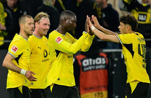 Dortmund's Guinean forward #09 Serhou Guirassy (2nd R) celebrates scoring the 1-1 goal with his teammates Dortmund's Italian forward #40 Samuele Inacio (R), Dortmund's German midfielder #10 Julian Brandt (2nd L) and Dortmund's German defender #03 Waldemar Anton (L) during the German first division Bundesliga football match between BVB Borussia Dortmund and Eintracht Frankfurt in Dortmund, western Germany on May 8, 2026. (Photo by INA FASSBENDER / AFP) / DFL REGULATIONS PROHIBIT ANY USE OF PHOTOGRAPHS AS IMAGE SEQUENCES AND/OR QUASI-VIDEO