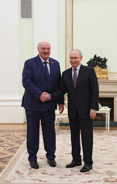 Russian President Vladimir Putin and Belarusian President Alexander Lukashenko shake hands during a meeting at the Kremlin in Moscow on May 8, 2026. (Photo by Ramil Sitdikov / POOL / AFP)