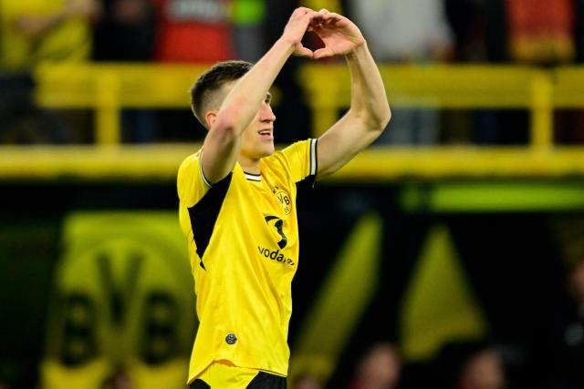 Dortmund's German defender #04 Nico Schlotterbeck makes the love heart gesture to fans as he celebrates scoring the 2-1 goal during the German first division Bundesliga football match between BVB Borussia Dortmund and Eintracht Frankfurt in Dortmund, western Germany on May 8, 2026. (Photo by INA FASSBENDER / AFP) / DFL REGULATIONS PROHIBIT ANY USE OF PHOTOGRAPHS AS IMAGE SEQUENCES AND/OR QUASI-VIDEO
