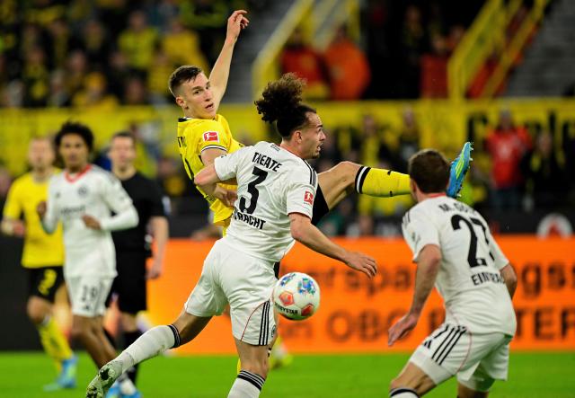 Dortmund's German defender #04 Nico Schlotterbeck and Frankfurt's Belgian defender #03 Arthur Theate vie for the ball during the German first division Bundesliga football match between BVB Borussia Dortmund and Eintracht Frankfurt in Dortmund, western Germany on May 8, 2026. (Photo by INA FASSBENDER / AFP) / DFL REGULATIONS PROHIBIT ANY USE OF PHOTOGRAPHS AS IMAGE SEQUENCES AND/OR QUASI-VIDEO