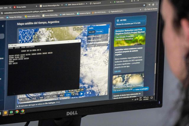 A worker of the Argentine National Meteorological Service (SMN) uploads recorded data to a database at the SMN office in the Piloto Civil Norberto Fernandez International Airport in Rio Gallegos, Santa Cruz province, Argentina on May 6, 2026. (Photo by WALTER DIAZ / AFP)