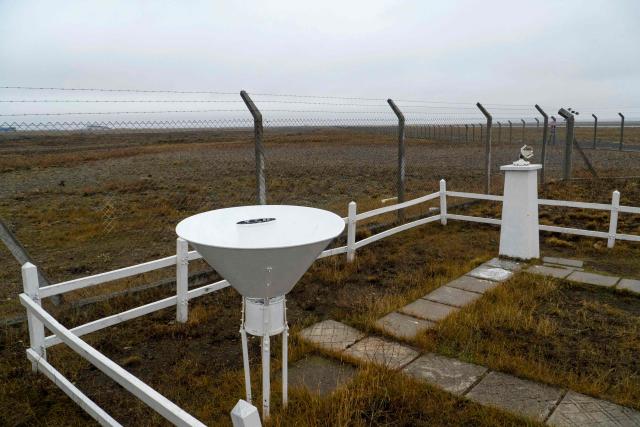 A snow gauge and a heliograph of the Argentine National Meteorological Service (SMN) are pictured at the observation field of the meteorological station, next to the runway of the Piloto Civil Norberto Fernandez International Airport, in Rio Gallegos, Santa Cruz province, Argentina on May 6, 2026. (Photo by WALTER DIAZ / AFP)