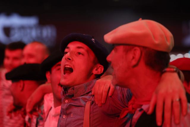 People dance during a big banquet organised by the 'Canon francais' in Montelimar, south-eastern France, on May 8, 2026. The banquets of the 'Canon francais', which draw thousands of guests around roast pork and red wine to "promote local traditions and heritage," are accused by their critics of spreading racist ideas behind their patriotic, typically French image. (Photo by Alex MARTIN / AFP)