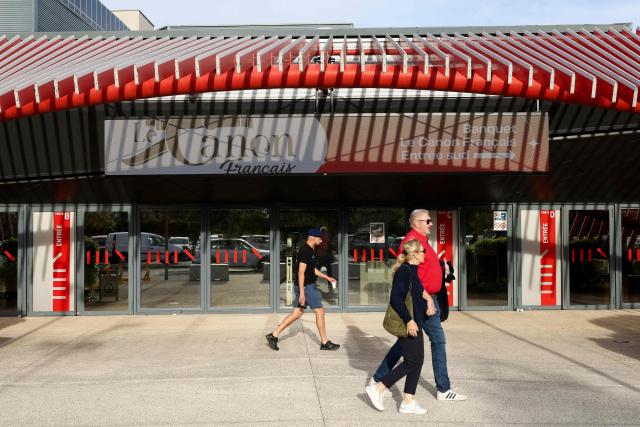 People arrive to attend a big banquet organised by the 'Canon francais' in Montelimar, south-eastern France, on May 8, 2026. The banquets of the 'Canon francais', which draw thousands of guests around roast pork and red wine to "promote local traditions and heritage," are accused by their critics of spreading racist ideas behind their patriotic, typically French image. (Photo by Alex MARTIN / AFP)