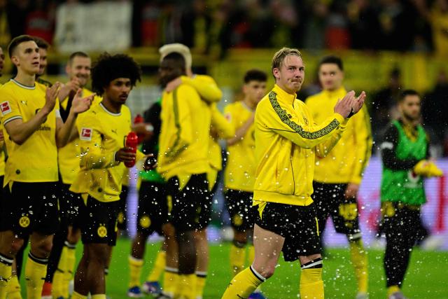 Dortmund's players including German midfielder #10 Julian Brandt (R) applaud their fans after the German first division Bundesliga football match between BVB Borussia Dortmund and Eintracht Frankfurt in Dortmund, western Germany on May 8, 2026. (Photo by INA FASSBENDER / AFP) / DFL REGULATIONS PROHIBIT ANY USE OF PHOTOGRAPHS AS IMAGE SEQUENCES AND/OR QUASI-VIDEO