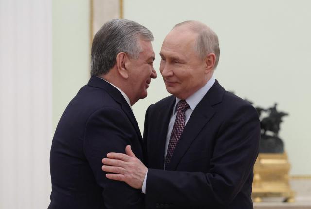 Russian President Vladimir Putin welcomes Uzbek President Shavkat Mirziyoyev during a meeting at the Kremlin in Moscow on May 8, 2026. (Photo by Ramil Sitdikov / POOL / AFP)