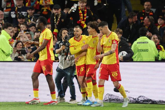 Lens' Portuguese midfielder #04 Mezian Mesloub Soares (C-R) is congratuled by teammates after scoring his team's first goal during the French L1 football match between RC Lens and FC Nantes at the Stade Bollaert-Delelis stadium in Lens on May 8, 2026. (Photo by Francois LO PRESTI / AFP)